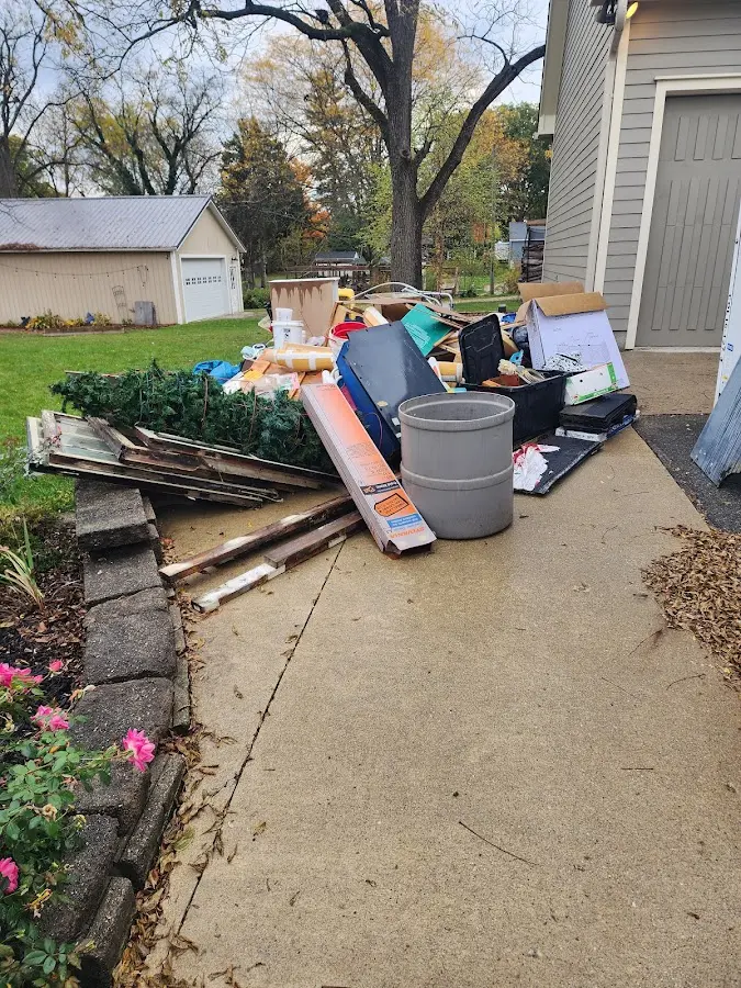 Dumpster being loaded with debris for Residential Dumpster Rental in Stapleton